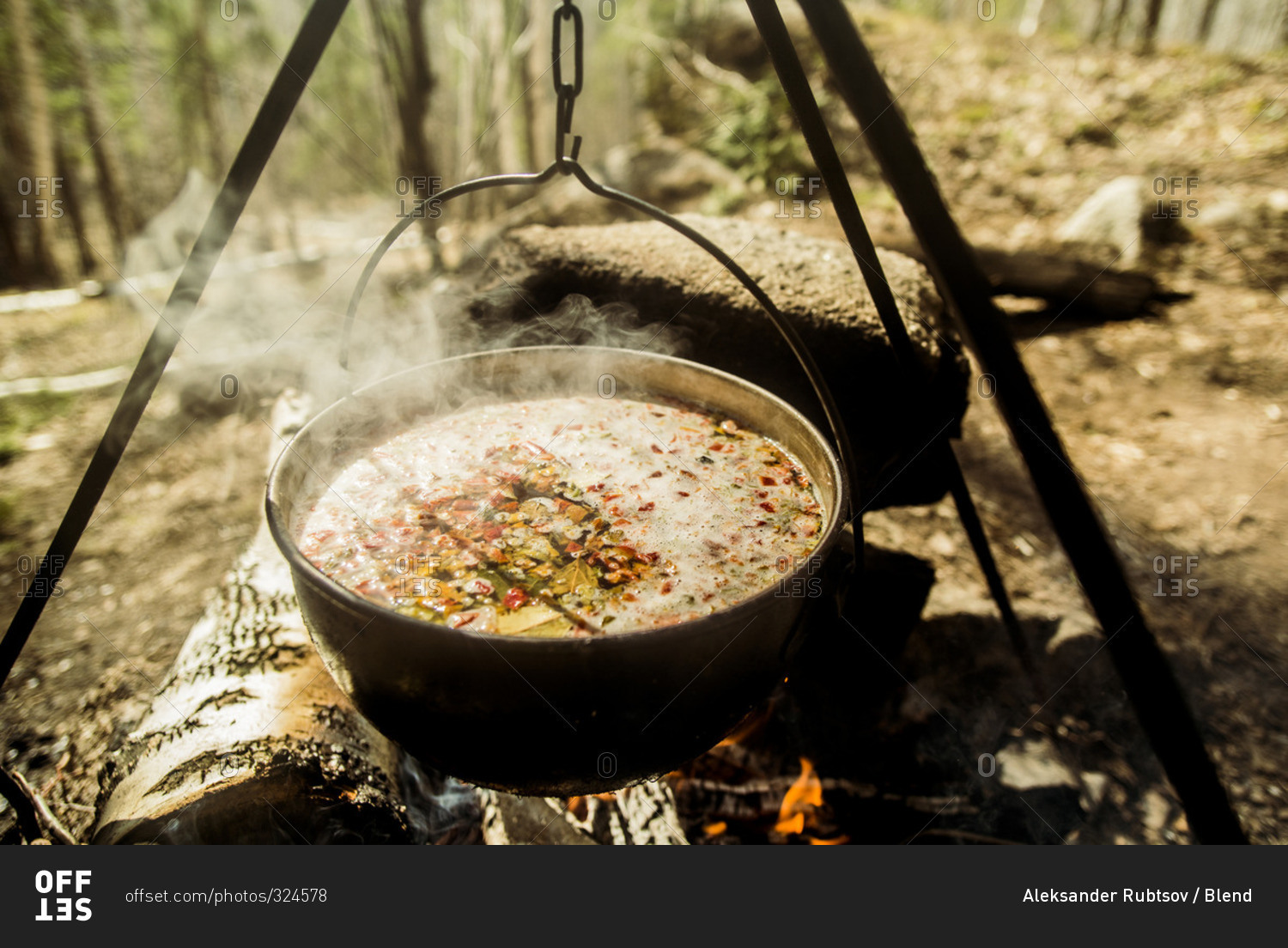 Close up of soup cooking over campfire