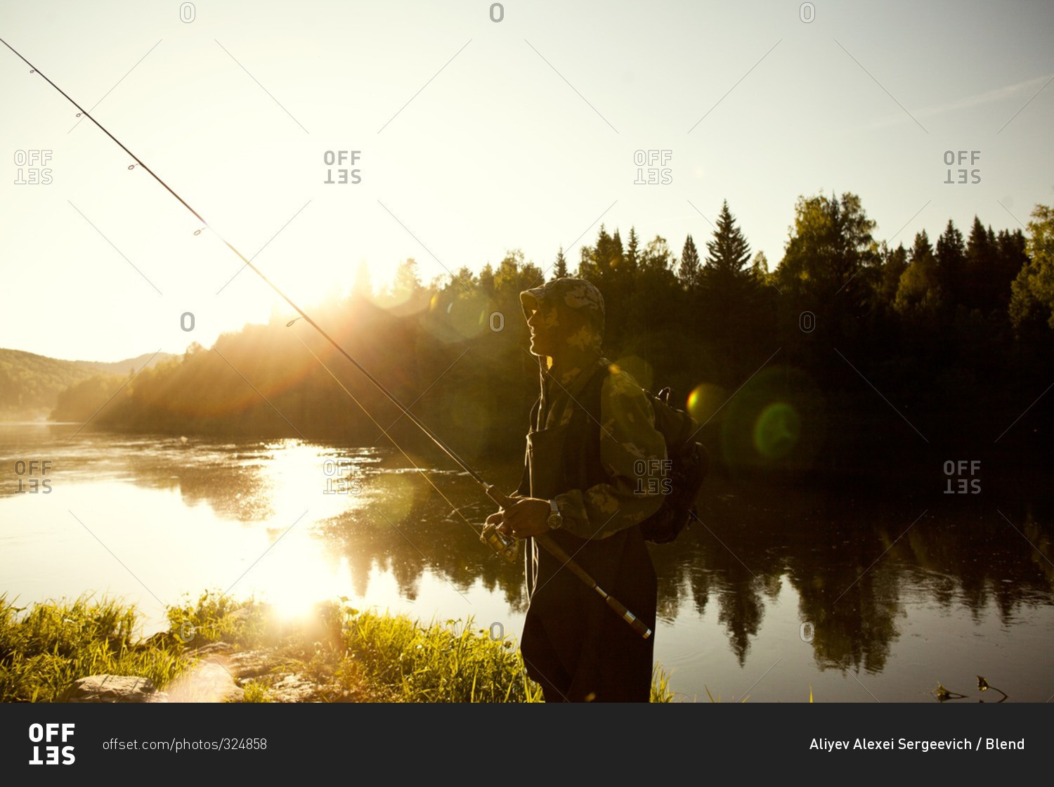 Man holding fishing rod at lake