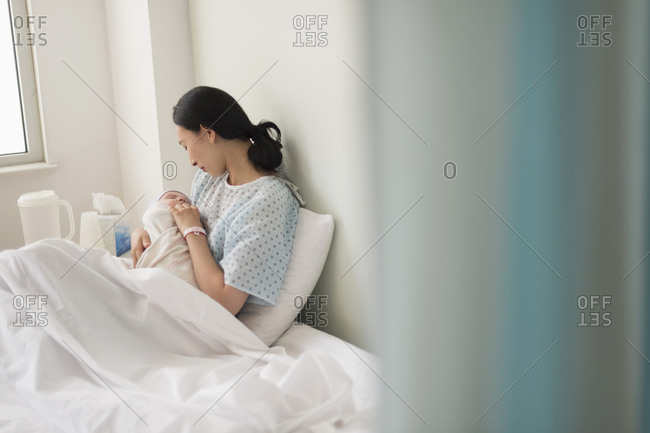 Mother holding newborn baby in hospital