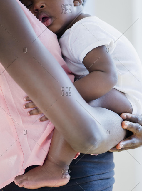 Mother holding sleeping son - Offset