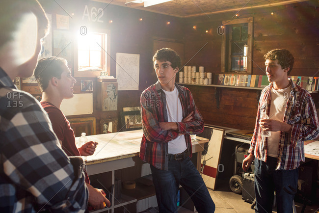 Teen boys collaborating in garage