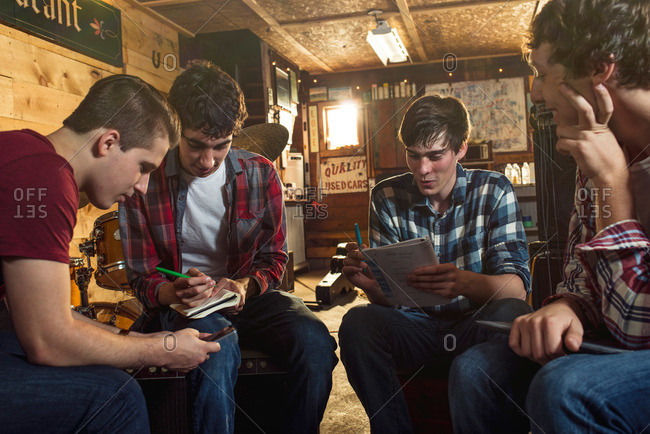 Teen boys writing songs in garage