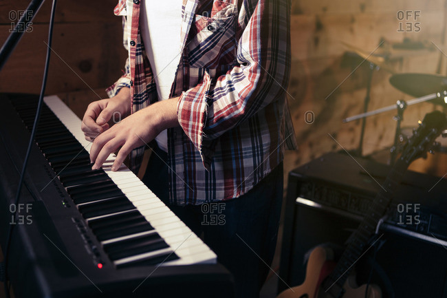 Teen playing a keyboard