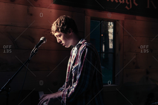 Teen at a keyboard playing