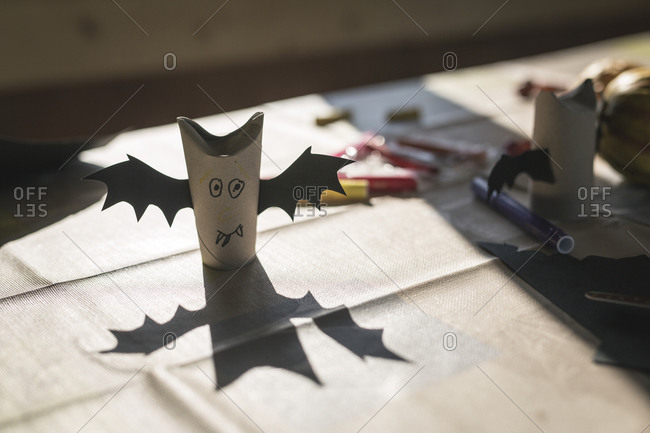 tinker small Halloween bat figure made of chestnut and paper. scissors and  fire match aside Stock Photo