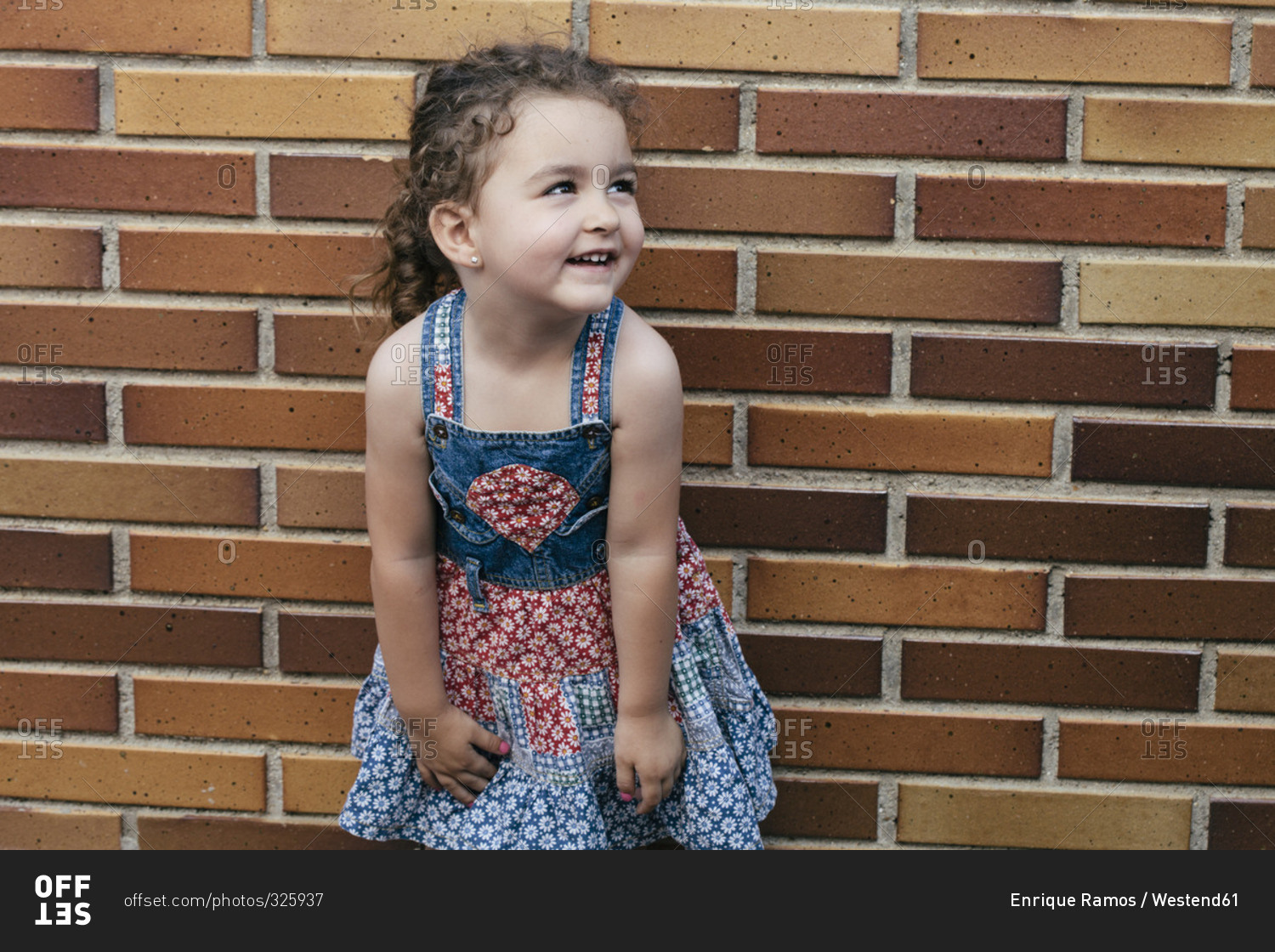 Portrait of smiling little girl wearing patterned summer dress