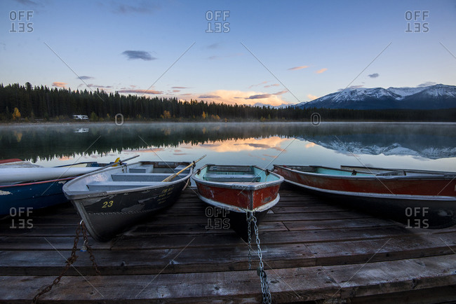 Boats chained to a dock on a mountain lake