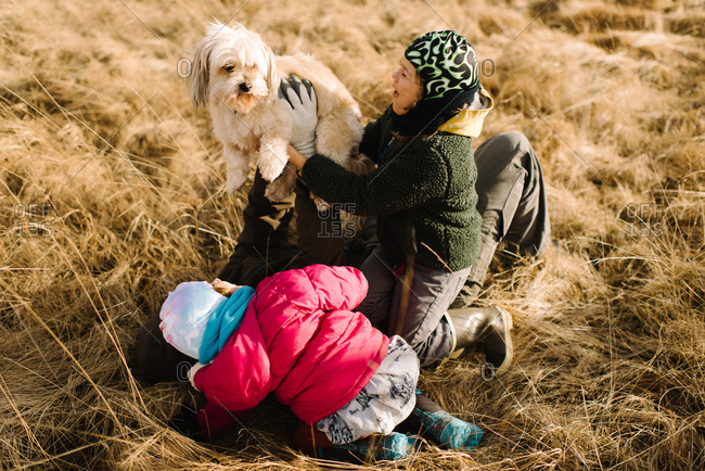 Family and dog playing