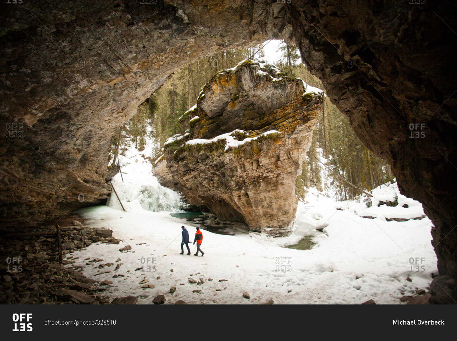 People exploring winter rock formations