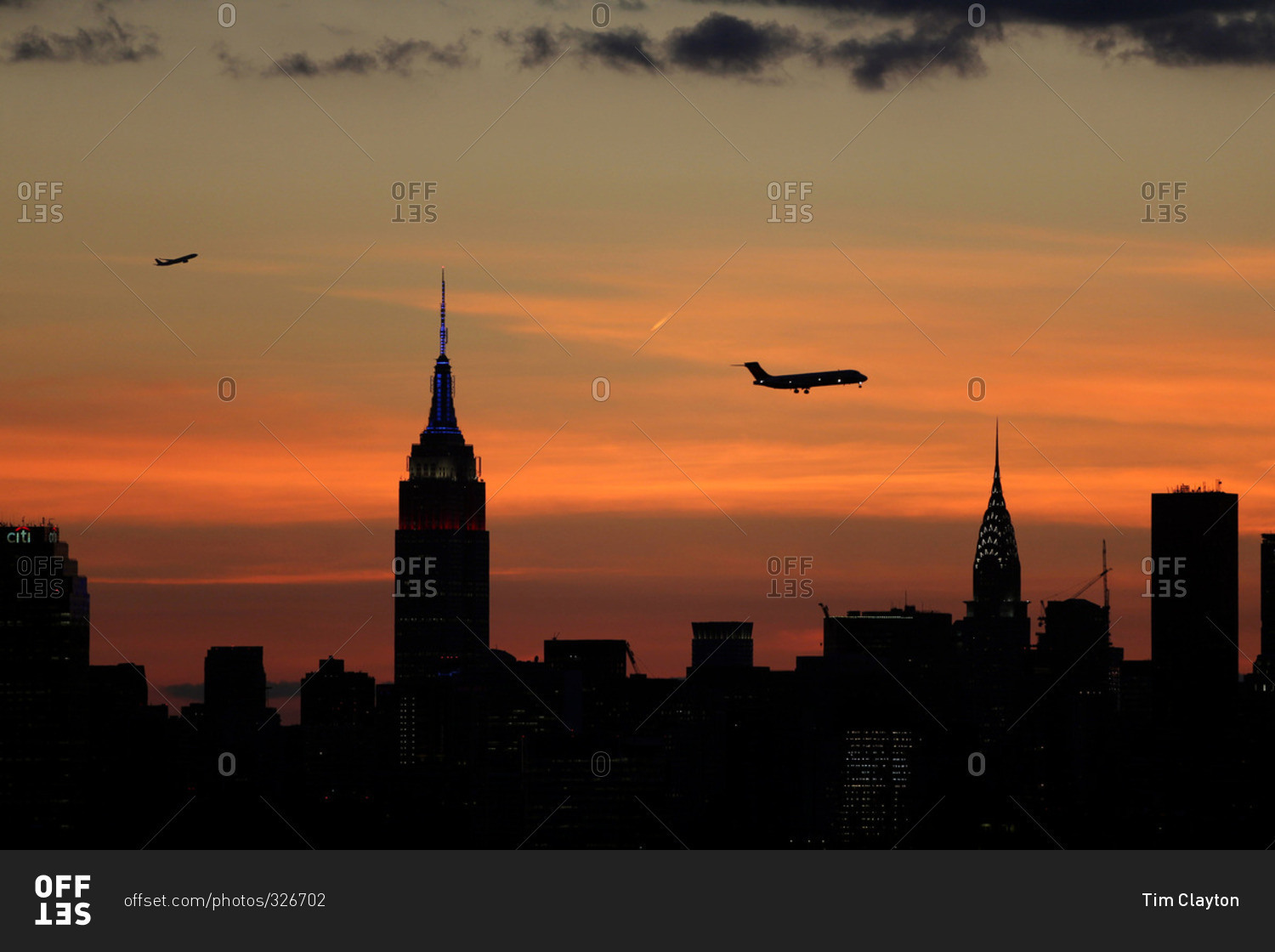 The sun setting behind the Manhattan skyline in New York City viewed from Flushing, Queens, New York