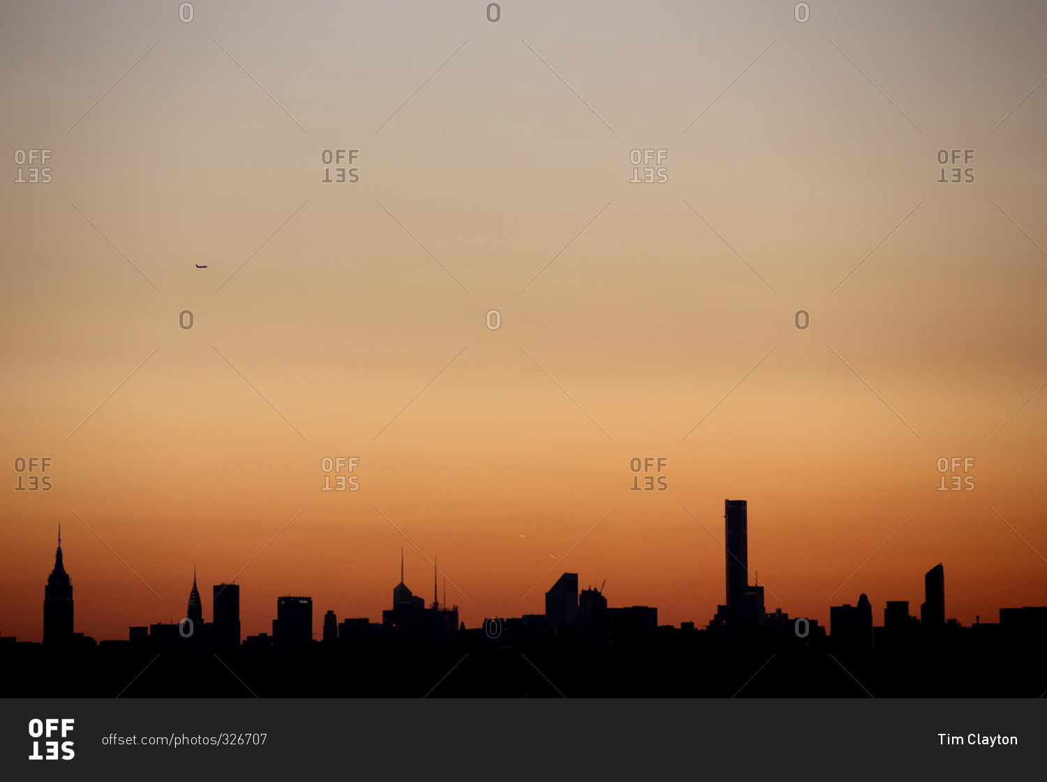 The sun setting in the Manhattan skyline in New York City viewed from Flushing, Queens, New York