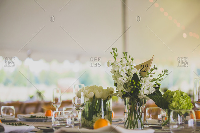 Simple Floral Centerpieces At An Outdoor Wedding Reception Stock