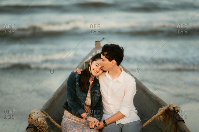 Couple sitting together on beach | Beach photo session, Beach poses with  friends, Beach photography poses