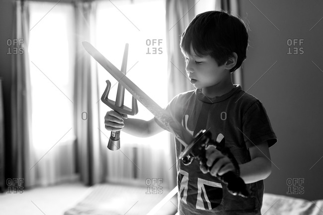 Boy playing with toy weapons