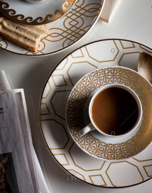 Cups of coffee on patterned saucers
