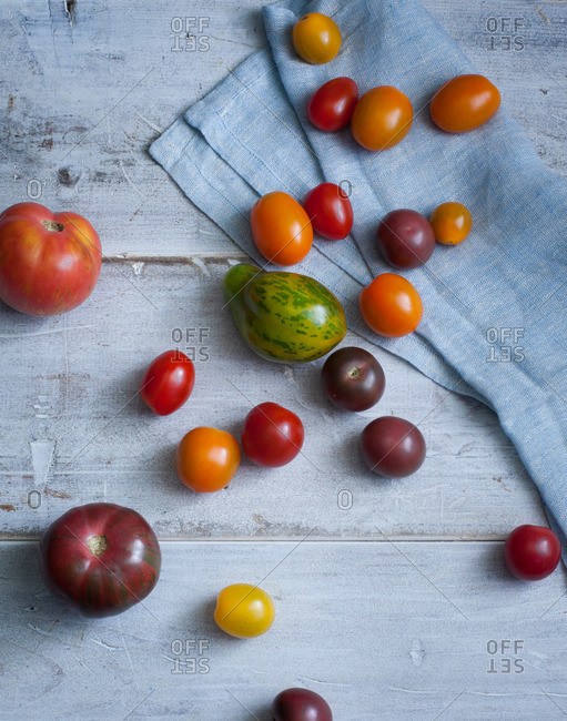 Various tomatoes on a wood background