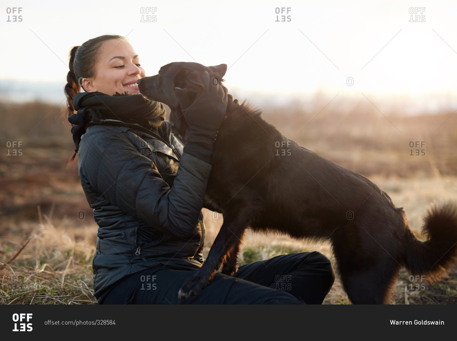 Woman playing with her dog in a field