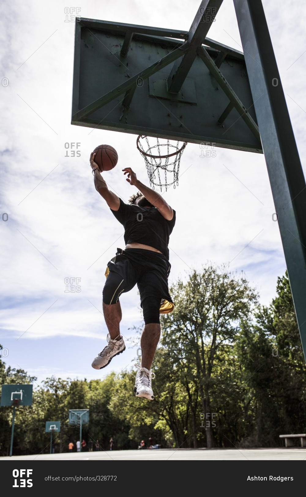 Man leaping for basketball dunk