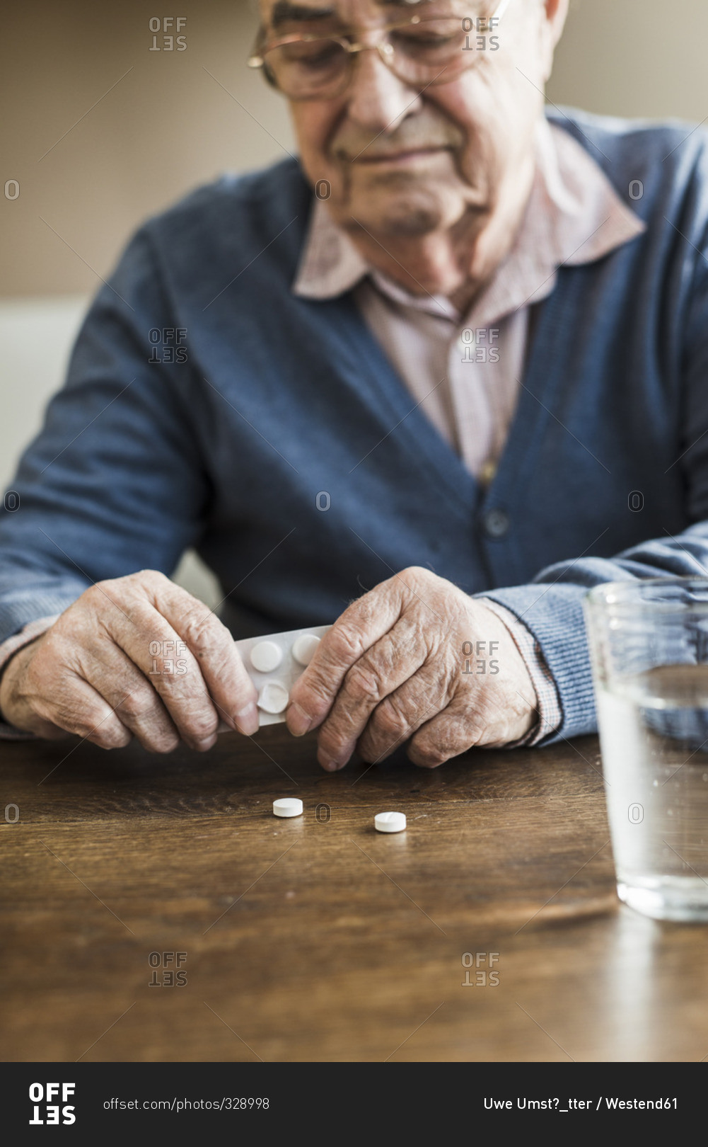 Senior man taking tablets out of blister pack, close-up