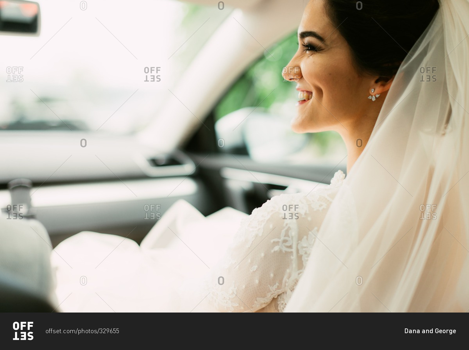 Smiling bride sitting in front seat of car