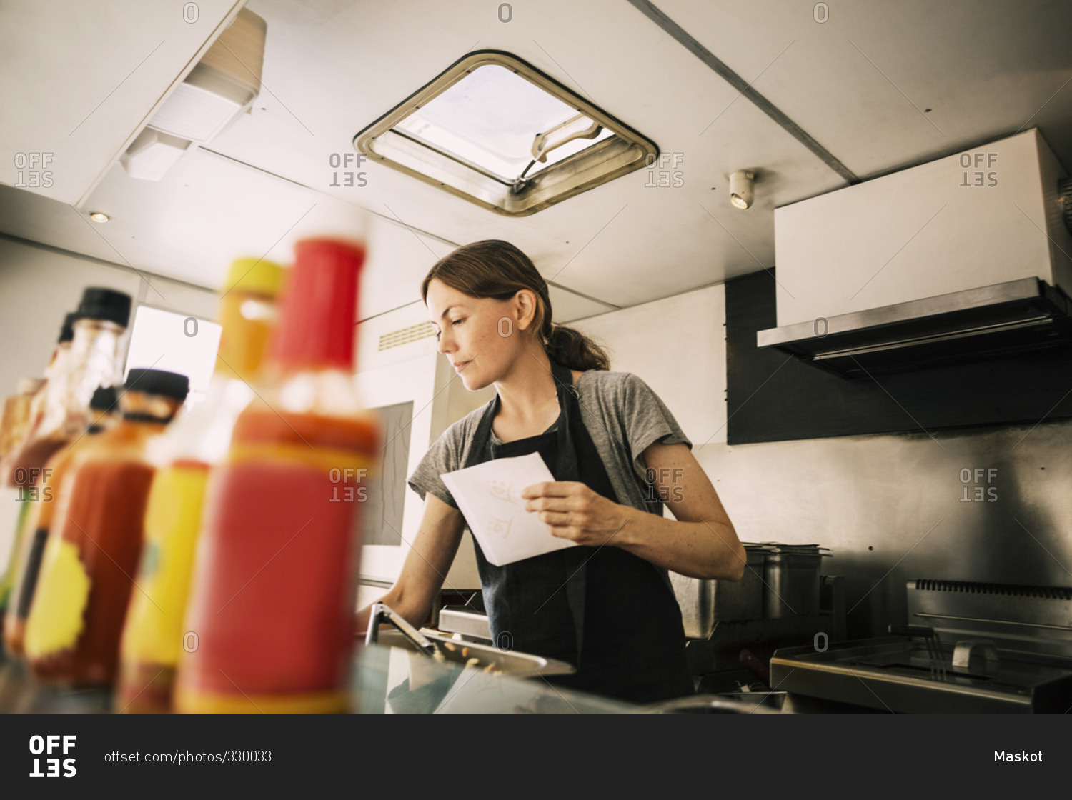 Female chef working in food truck