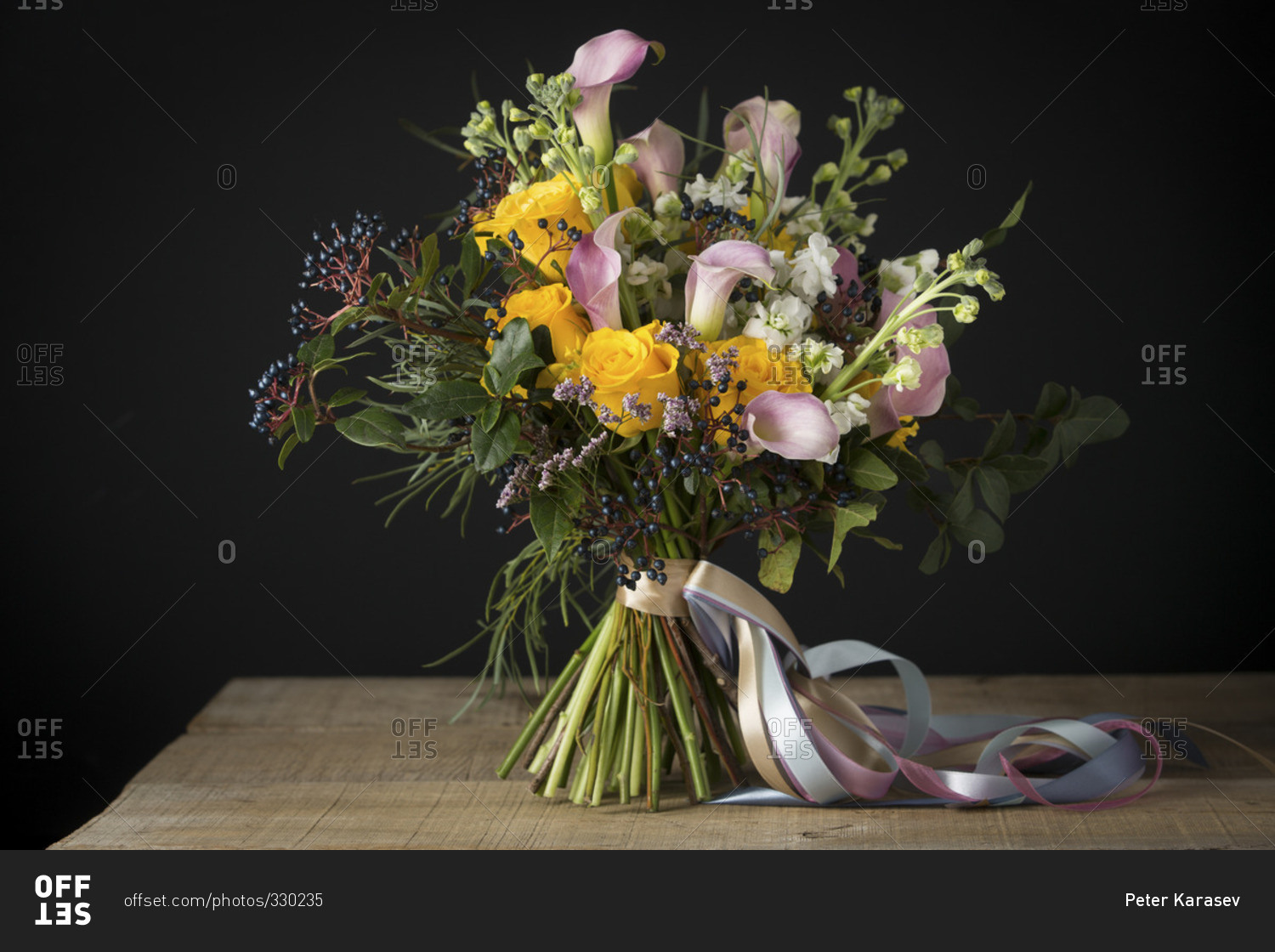A bouquet of flowers on a table in front of a black background