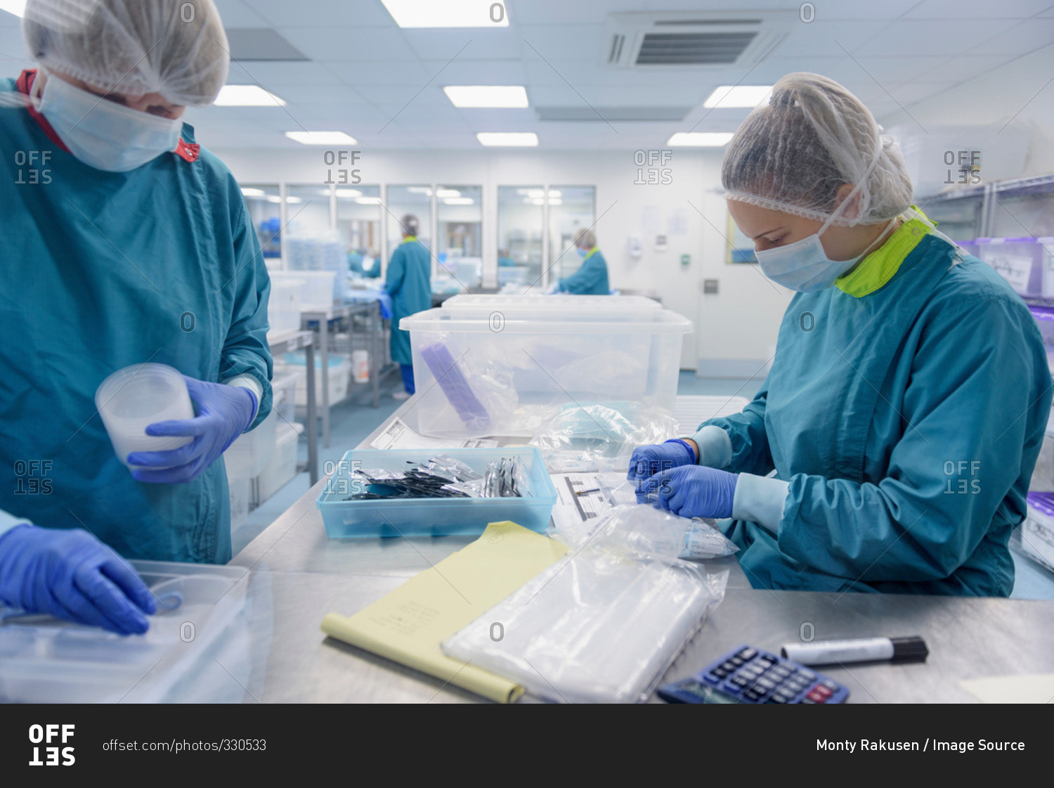 Workers packing and checking surgical instruments in clean room of surgical instruments factory