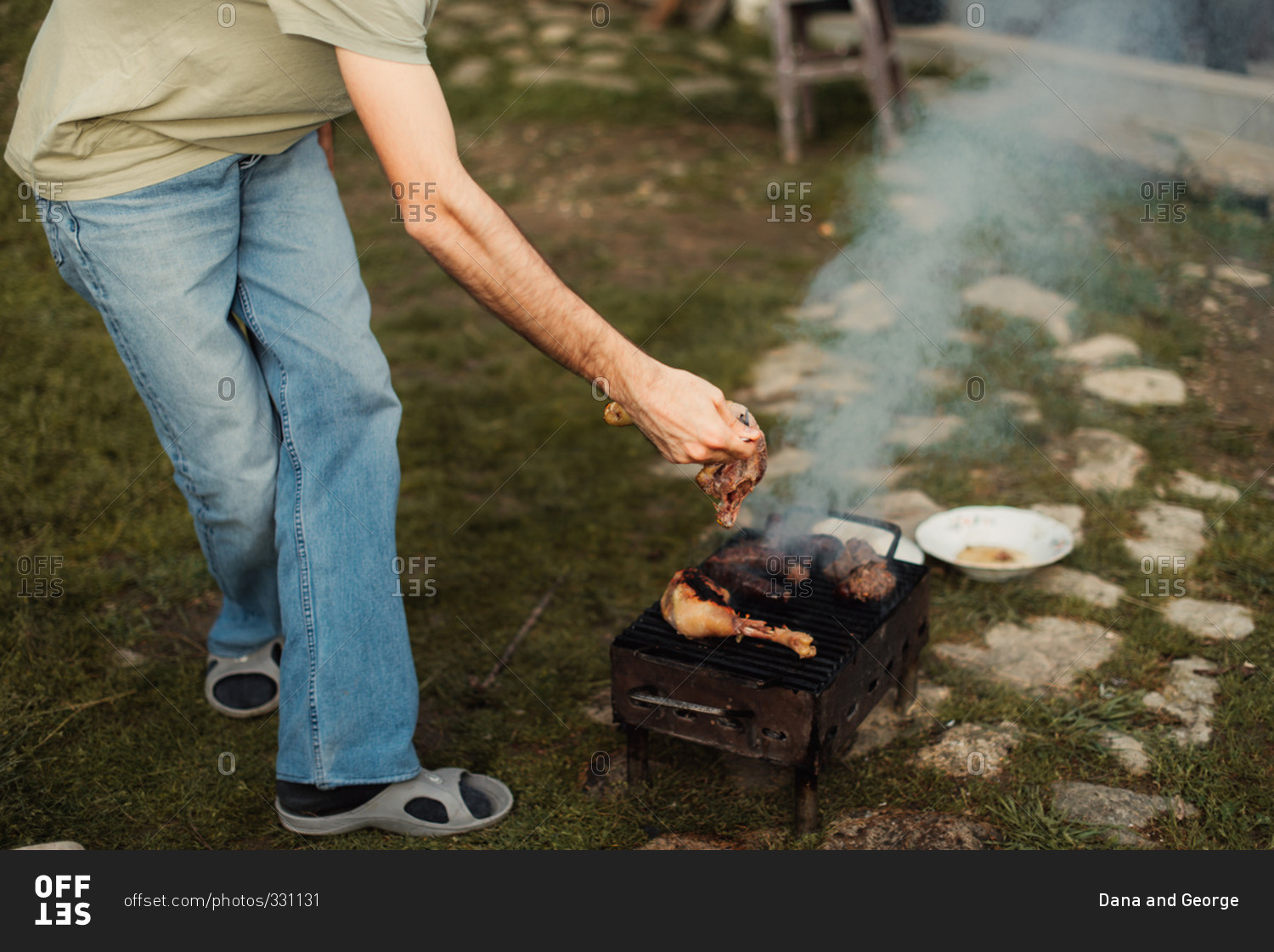 Man cooking food on small grill