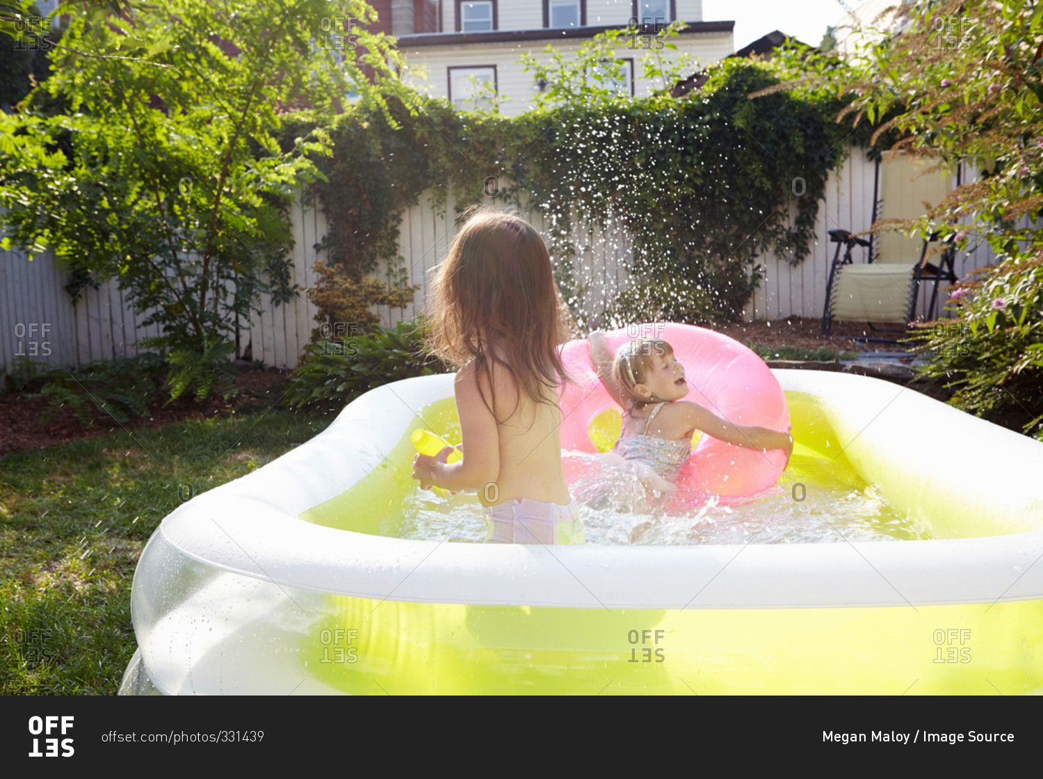 Girls splashing in inflatable pool
