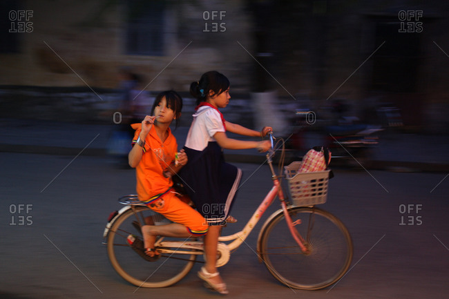 Two girls on outlet bike