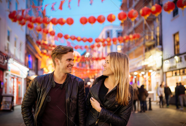 Young couple strolling at night, Chinatown, London, England, UK