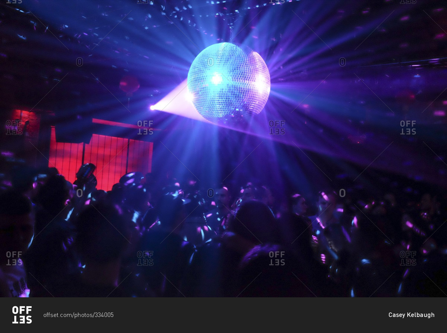Disco ball and people dancing in a night club