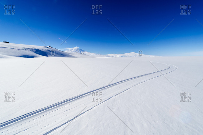 Skiddoo tracks cross the snow on the vast barren Ross Ice Shelf