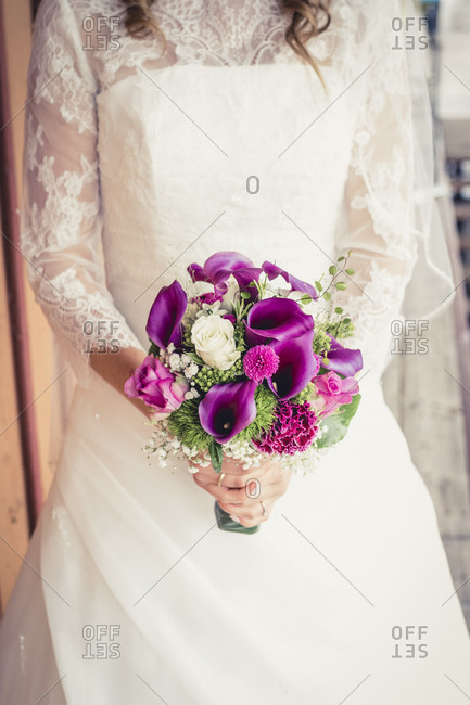 Bride holding lily bouquet - Stock Image - Everypixel