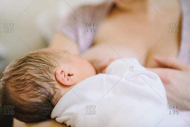 Woman nursing her newborn baby
