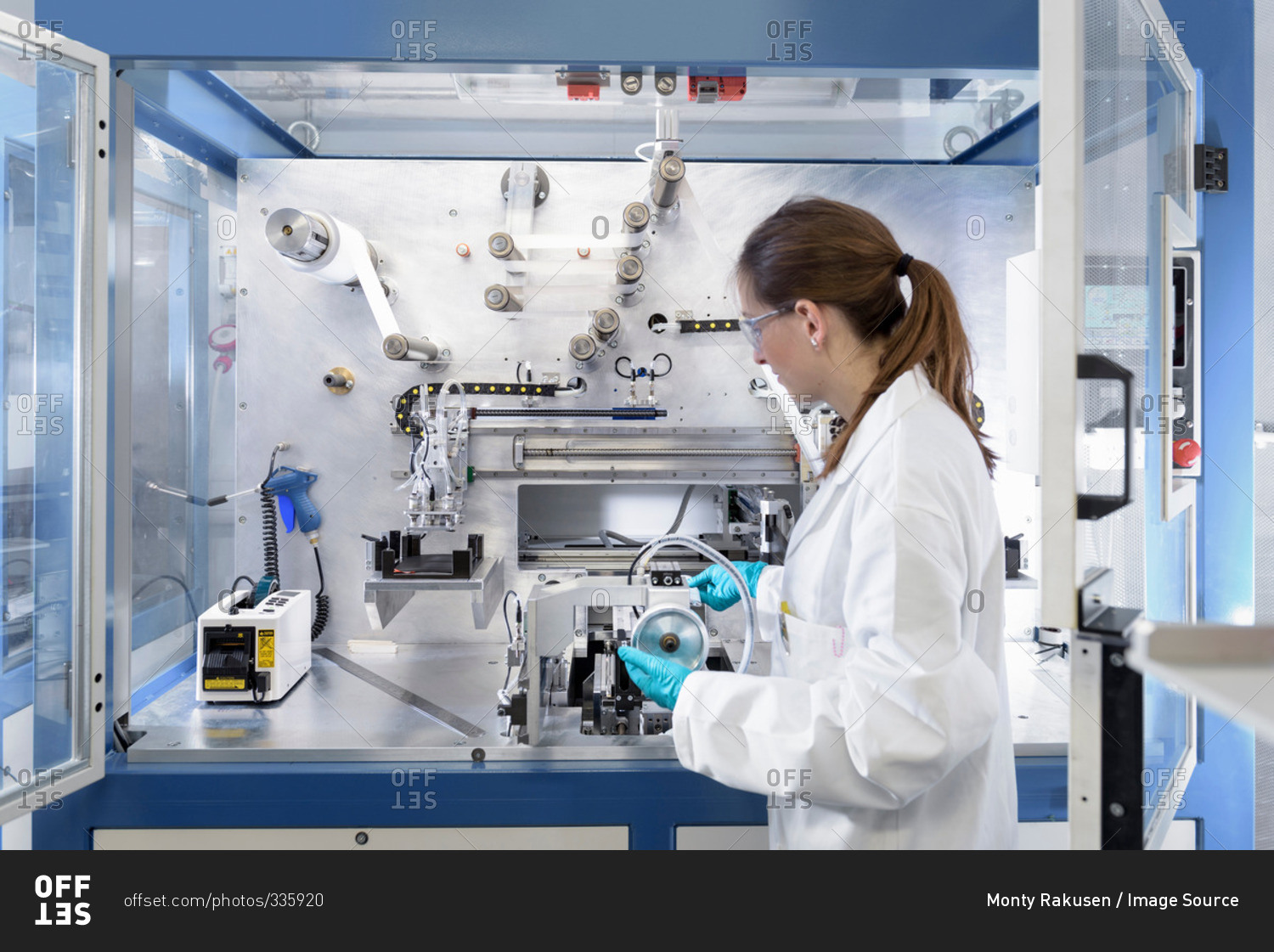 Female scientist making lithium ion battery samples in battery research facility