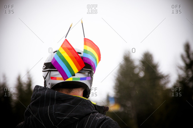 Person with rainbow flags on helmet
