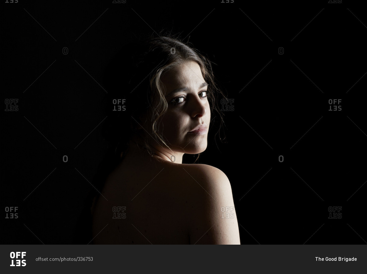 shirtless young woman looking back over her shoulder stock photo offset shirtless young woman looking back over