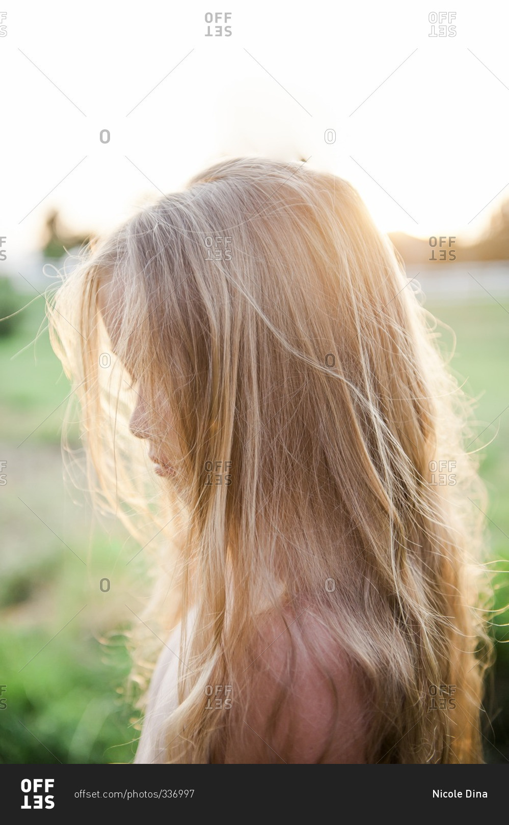 Portrait of a little blonde girl with hair covering her face stock photo -  OFFSET