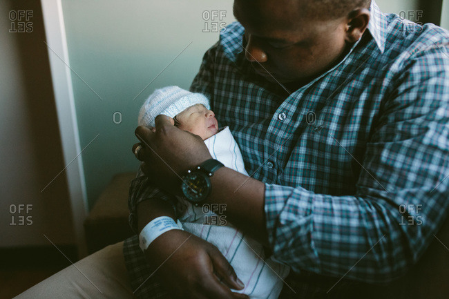 A dad holding his newborn