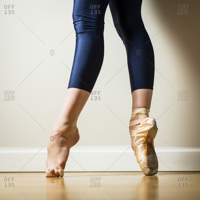 Ballerina balancing on toes stock photo - OFFSET