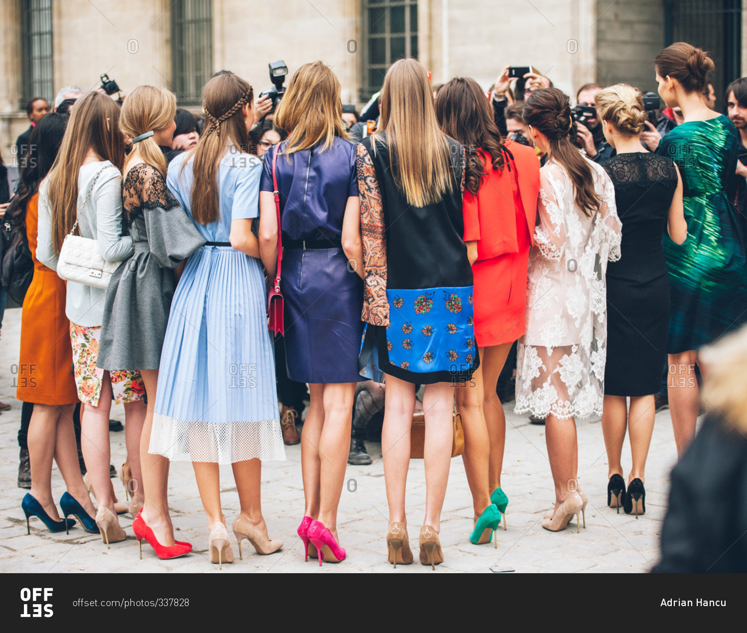 Models on high heels posing to photographers stock photo - OFFSET