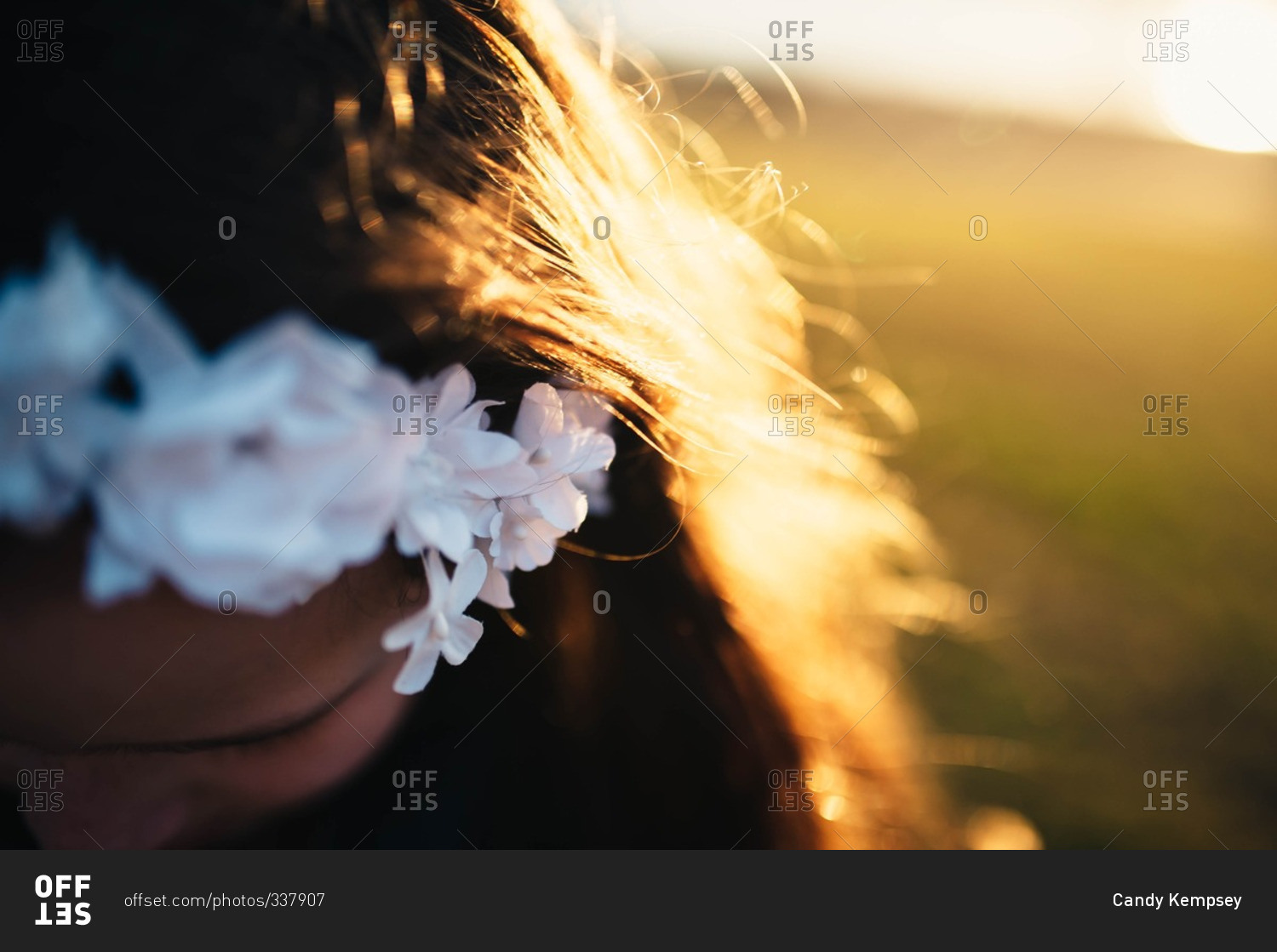 Girl wearing a floral headband in the late afternoon sun
