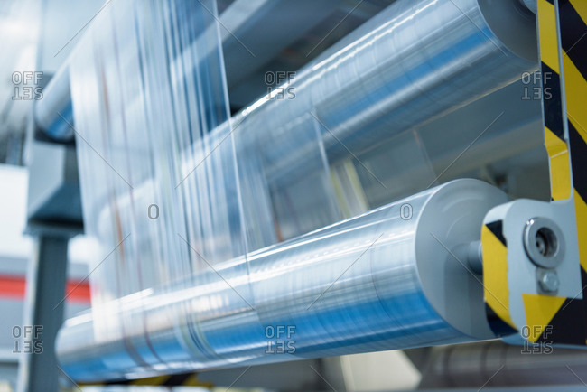 Rolls of printed plastic film in food packaging printing factory