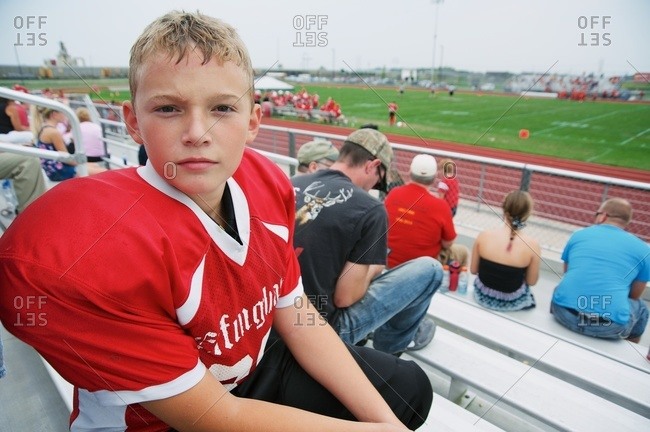 Boy in football jersey at game