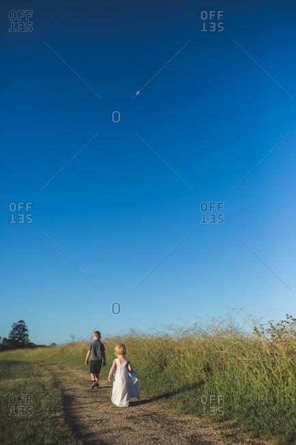 Two children walking on a country path
