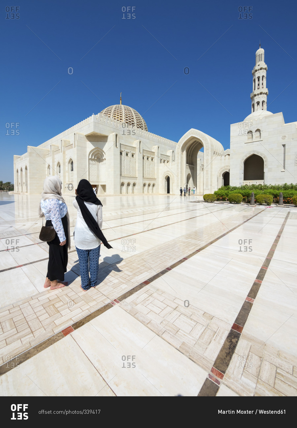 Two wonem walking at Sultan Qaboos Grand Mosque in Oman