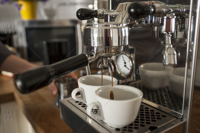 Modern coffee machine on table in kitchen Stock Photo by ©serezniy