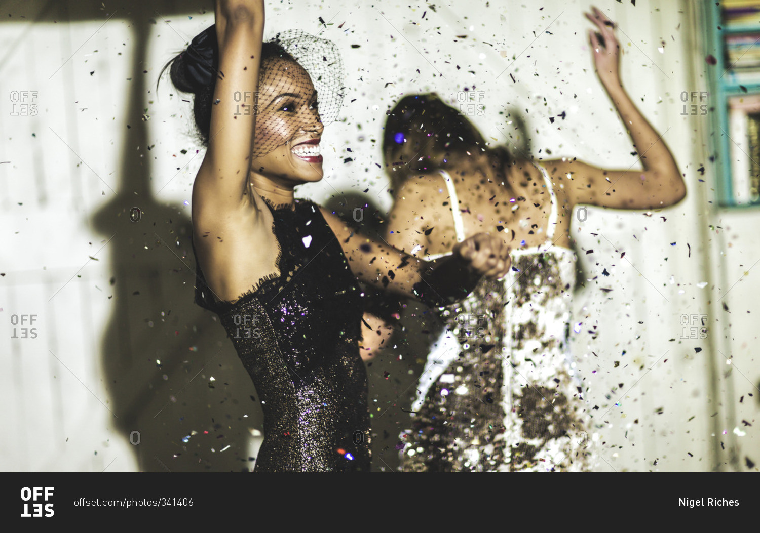 Friends celebrating at a party with confetti