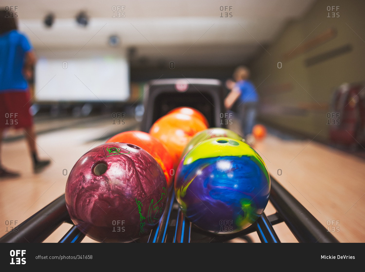 Closeup of bowling balls on a return at bowling alley stock photo OFFSET